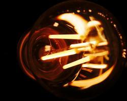 A lightbulb lit up on a dark background