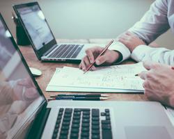 A photo of a laptop and some supporting tools