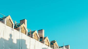 Photo of a few rooftops and blue sky