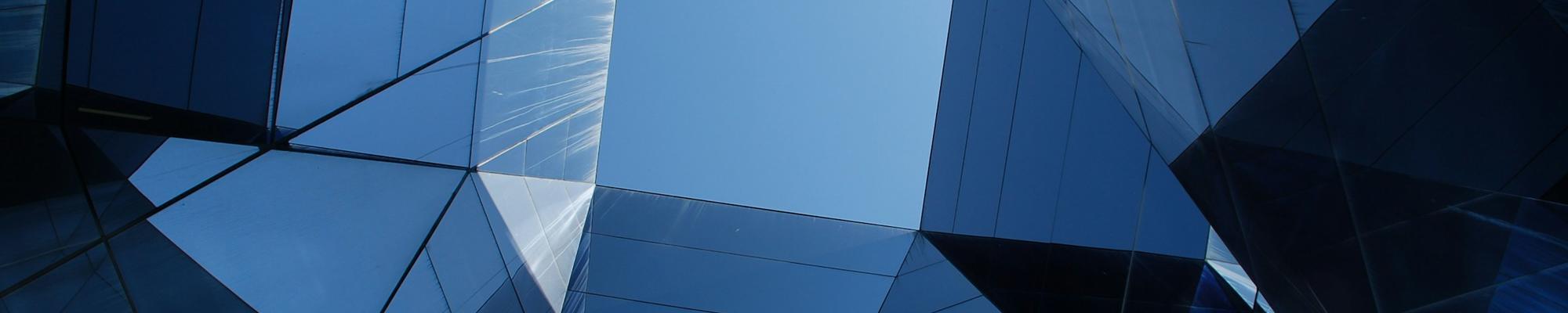 A building with curved glass and view to the sky